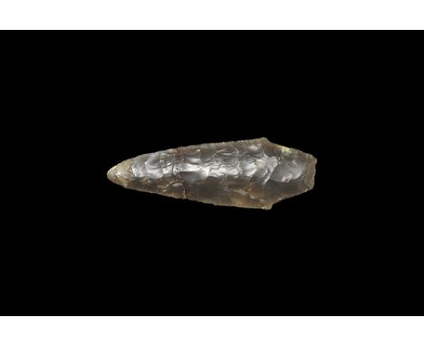 Neolithic, 4th-3rd millennium BC.
A fully bifacially knapped spearhead of thick lentoid section with shouldered tang; in a tr