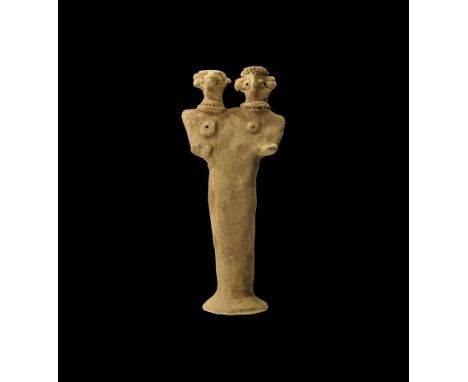 1180-700 BC. 
A flat-backed ceramic figurine depicting a female with two heads; the eyes and breasts formed with round recess