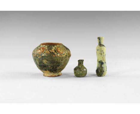 10th-14th century AD. 
A mixed group comprising: a glass cylinder flask, ribbed with rounded underside; a squat glass ampulla