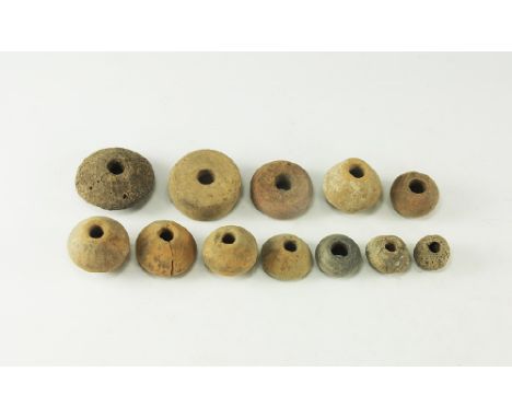 9th-11th century AD. 
A mixed group of ceramic spindle whorls including biconical, biconvex, melon and discoid types. 251 gra