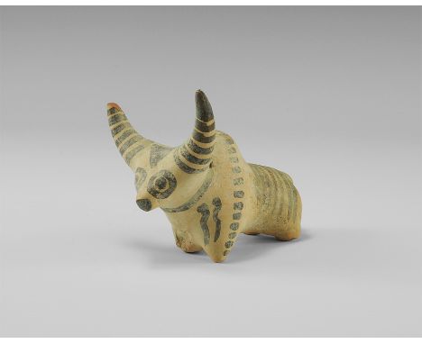2nd millennium BC. 
A ceramic figurine of a zebu with exaggerated crescent horns, painted with stripes to the horns and rump,