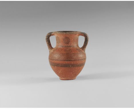 10th-5th century BC. 
An Iron Age ceramic red ware amphoriskos with bulbous body, broad neck everted rim, two lateral round-s