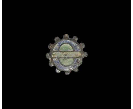 2nd century AD.
A bronze plate brooch with radiating lugs to the border, enamelled theta motif in blue and green; spring, pin
