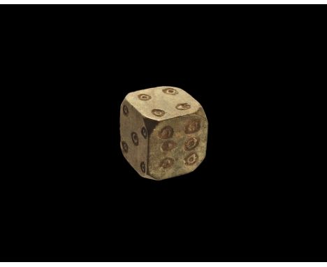 1st-3rd century AD.
A large carved steatite(?) dice, cuboid in form with chamfered corners, ring-and-dot markings arranged 1: