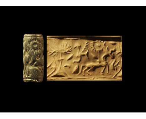 3rd millennium BC. 
A carved lapis lazuli cylinder seal with frieze of a horned animal, bird, tree and radiant sun. 4.22 gram