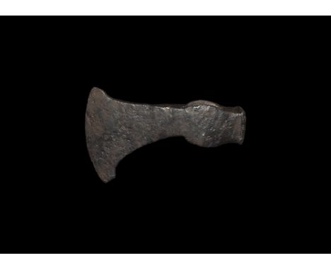 9th-12th century AD. 
A small hand-forged iron axehead with curved blade, small wings to the socket and hammer to the rear. 4