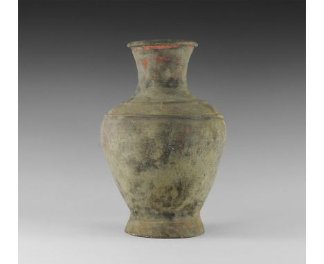 Han Dynasty, 206 BC-220 AD. 
A bulbous ceramic vase with flared base, deep shoulder with raised circumferential rings, waiste