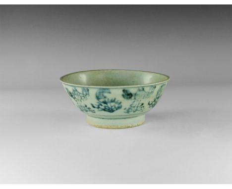 19th century AD. 
A blue-glazed bowl with narrow flared rim, shallow basal ring; blue floral motifs to the outer face. 231 gr