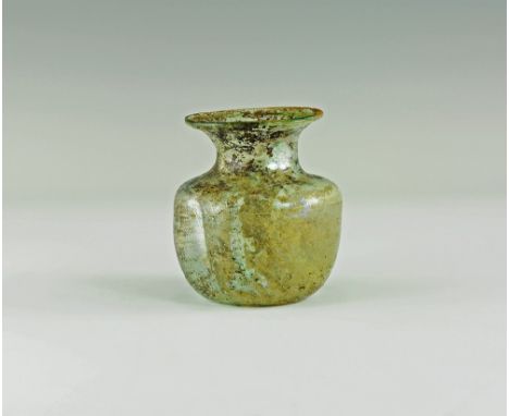 3rd-4th century AD.
A glass jar with drum-shaped body, dimple base, deep shoulder with broad neck and flared rim; iridescence
