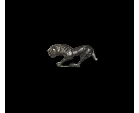 2nd century AD.
A bronze plate brooch of a lion in profile facing left on a baseline with hunched shoulders and lowered tail;