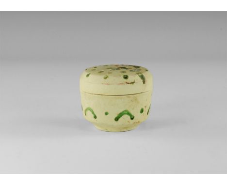 14th-15th century AD.
An unglazed squat ceramic box with basal ring, green enamel spots to the lid crescents and pellets to t
