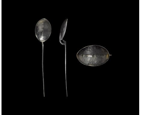 3rd century AD. 
A silver baptismal spoon with shallow scaphoid bowl with carinated underside, scrolled neck, square-section 