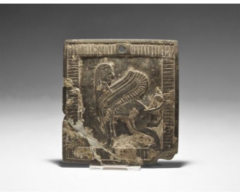 9th-8th century BC. 
A square stone plaque pierced for suspension with billetted border enclosing a reserved figure of a rega