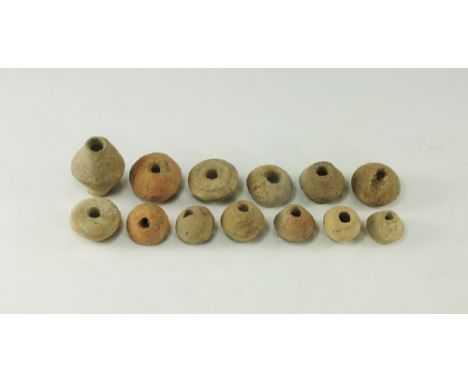 9th-11th century AD. 
A mixed group of ceramic spindle whorls including biconical, biconvex and irregular spherical types. 31
