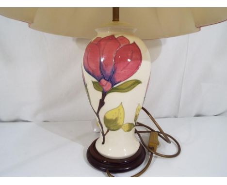 Moorcroft Pottery - a large table lamp decorated with pink magnolia on an ivorine ground with original Moorcroft shade, the l