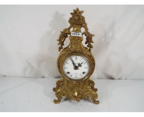 An ornate Italian mantel clock with relief decoration, white dial with Roman numerals marked Imperial to the dial