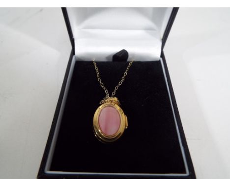 A lady's 9 carat gold mother of pearl oval locket, approx 2.8 gm, chain approx 46 cm (unused surplus retail stock) - Est £25 