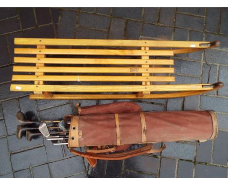 A Davos vintage wooden sleigh and a set of wooden shaft golf clubs in bag