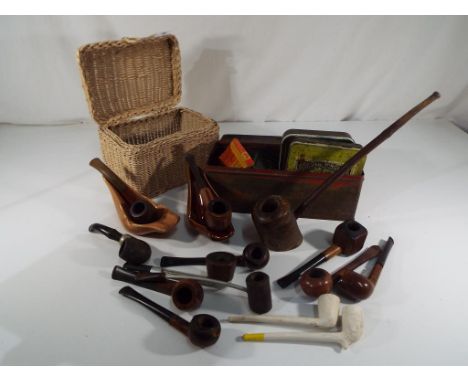 A good collection of smoking pipes and ceramic pipe holders and a quantity of tobacco tins