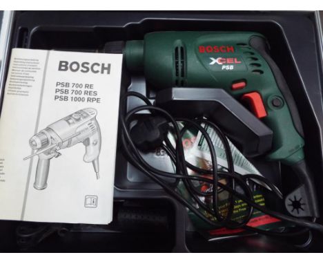 A Bosch Xcel PSB electric drill with accessories, carry case and manual