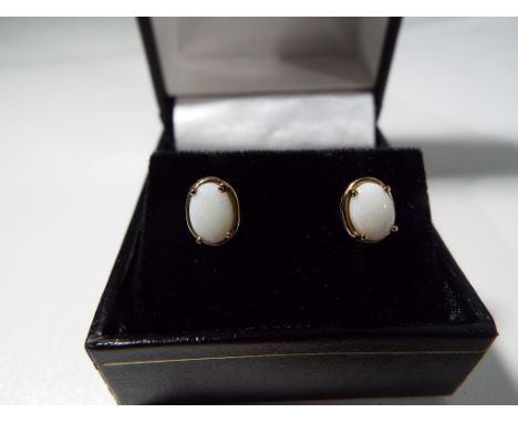 A lady's 9ct gold and opal stud earrings, Est £15 - £30