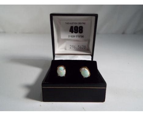 A lady's 9 carat gold and opal stud earrings, boxed