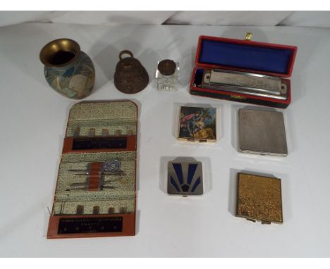 A good lot to include 2 powder compacts, 2 folding mirrors, a glass inkwell, a sewing set, "Super Chrominica" chromatic harmo