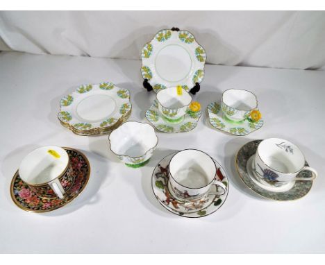 Aynsley - a part tea service decorated with buttercup handles comprising eleven pieces and three Wedgwood cabinet cup and sau