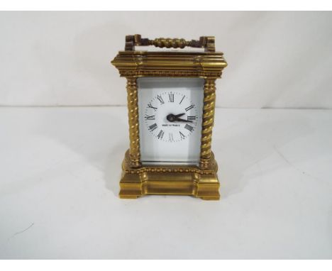 A decorative mechanical carriage clock, the case flanked by barley twist columns to the four corners and matching twist desig