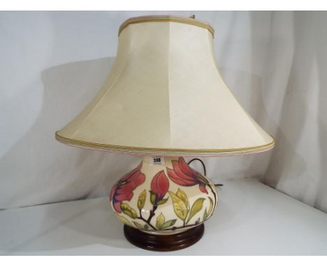 Moorcroft Pottery - a large table lamp decorated with pink magnolia on an ivorine ground with original Moorcroft shade, the l