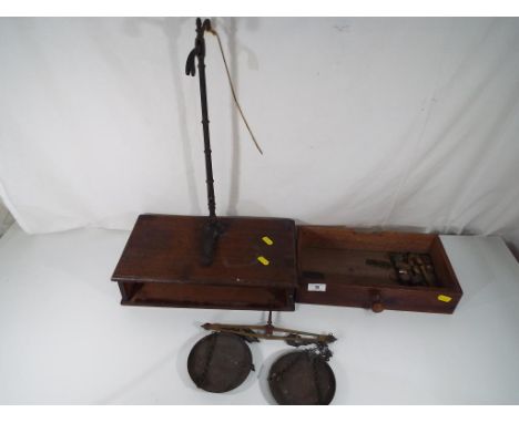 A set of balance scales and weights by H Pooley & Son Ltd. in wooden box.