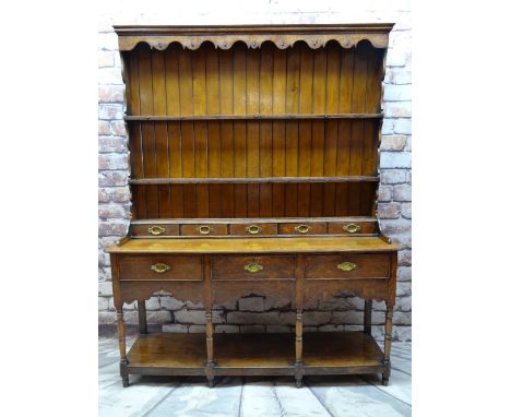 GEORGE III WELSH OAK DRESSER, boarded delft rack with scalloped frieze, integral bank of five spice drawers between shaped up