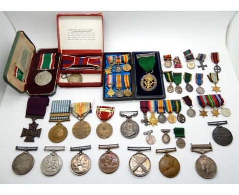 A lot comprising a Korea medal, a USA medal, a territorial medal, a woman's voluntary service medal, a coronation medal, a re