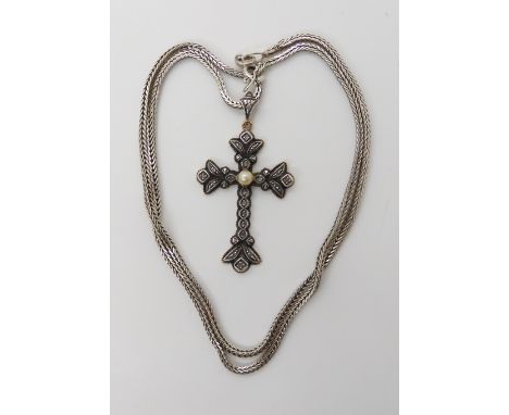 A continental yellow and white metal diamond and pearl set cross with a silver herringbone chain weight 12.2gms Condition Rep