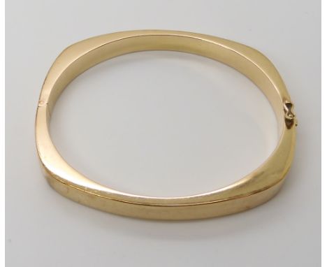 A 9ct gold bangle internal dimensions 6cm x 5.4cm, width 0.6cm, weight 15.6gms Condition Report: Available upon request
