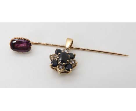 A yellow metal purple sapphire set stick pin, silk inclusions are visible, dimensions 10.5mm x 7.2mm, together with a yellow 