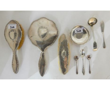 A lot comprising a three piece silver dressing table set, a silver dish set with a Hong Kong five dollar 1976, an EP toddy la