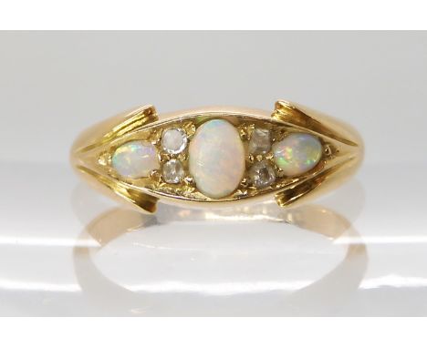 An 18ct gold opal and diamond ring, hallmarked Birmingham 1899, size N, weight 3.4gms Condition Report: The surface of all th