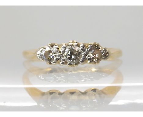 An 18ct and platinum three stone diamond ring of estimated approx 0.21cts, finger size H1/2, weight 2gms Condition Report: Av