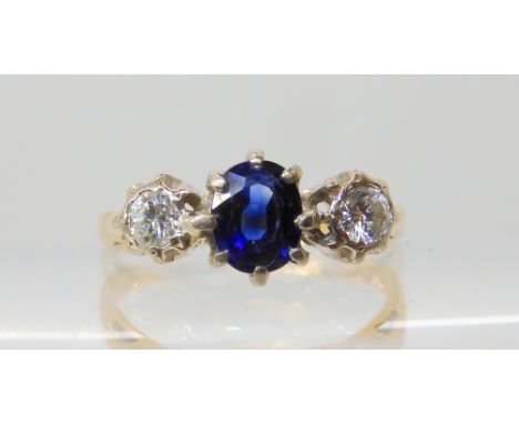A sapphire and diamond three stone ring, the central sapphire is approx 5.6mm x 4.4mm x 3.8mm, diamonds approx 0.20cts combin