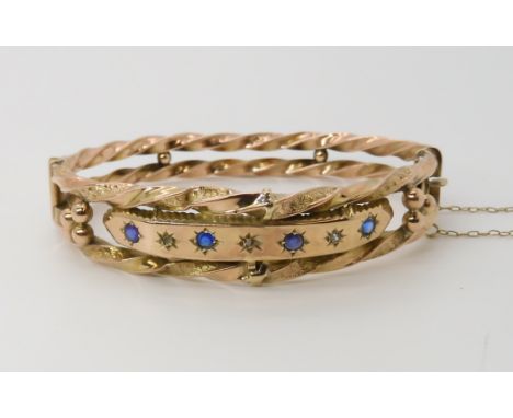 A 9ct gold blue and clear gem set bangle (af) weight approx 10.6gms Condition Report: Available upon request