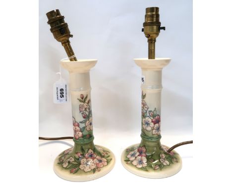 A pair of Moorcroft apple blossom pattern candlestick table lamps Condition Report: Crazing to both 