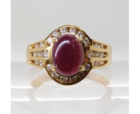 A 14k gold ruby cabochon and diamond ring, finger size Q, weight 5.1gms Condition Report: Available upon request