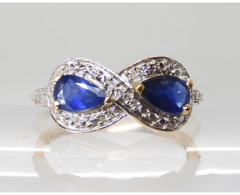 A 9ct gold infinity designed sapphire and diamond accent ring, head size 8mm x 16.2mm, finger size O, weight 2.2gms Condition