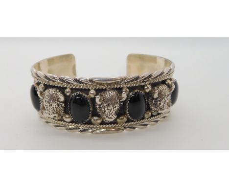 A silver buffalo head and black onyx native American style bangle, Condition Report: No condition report available for this l