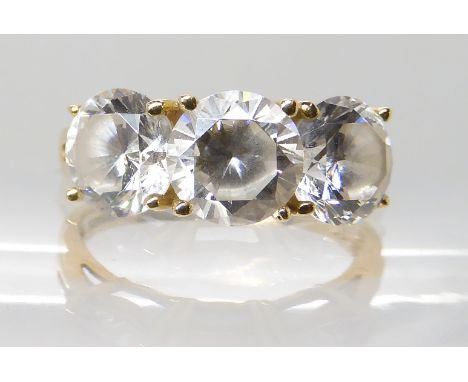 A 14k gold three clear gem set ring, finger size M1/2 Condition Report: Available upon request