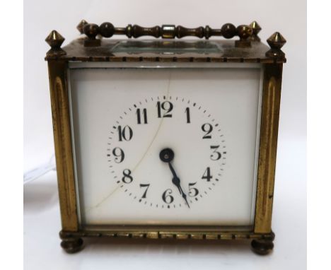 A brass and glass cased carriage clock, the movement with incised lion motif Condition Report: enamel dial cracked 