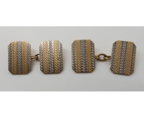 A pair of 9ct gold striped, engine turned engraved cufflinks, head size 1.6cm x 1.1cm, weight 6.5gms Condition Report: Availa