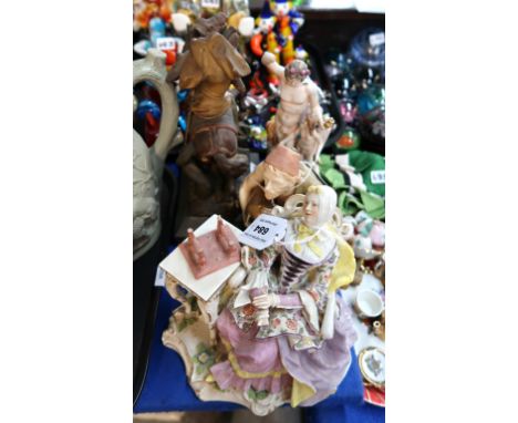 A Royal Worcester figure of a water carrier, no 637, a Meissen figure of a seated woman, a Naples figure group and a painted 
