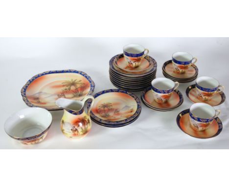 A JAPANESE PORCELAIN TEA SERVICE, PRINTED WITH DESERT SCENES, FOR 12 PERSONS 